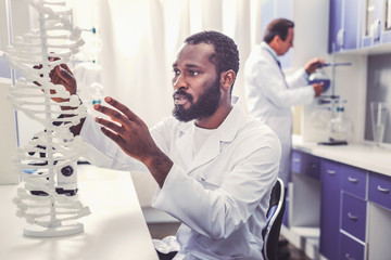 Young bioengineer studying molecular chain model