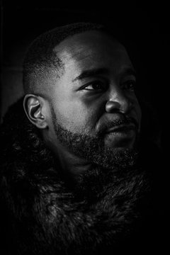 Close Up Black And White Photo Of A Black Man Against A Dark Background