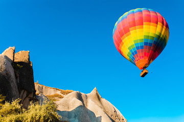 Colorful hot air balloon flying over at fairy chimneys in Nevsehir, Goreme, Cappadocia Turkey. Hot...