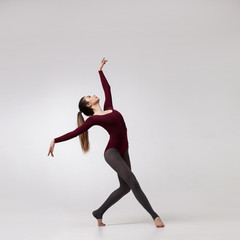 young woman dancer in maroon swimsuit posing - 246886277