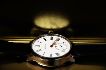 Beautiful handmade wristwatches on a golden background.