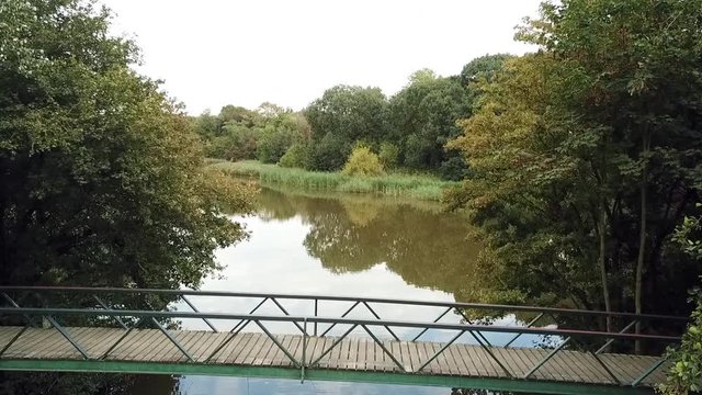 Drone flying over a small bridge in a park. Dronten, Netherlands.