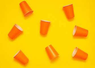 Plastic cups on yellow background. Plastic free concept.

