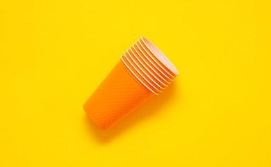 Fototapeta na wymiar Plastic cups on yellow background. Plastic free concept. 