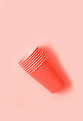 Plastic cups on living coral background.
