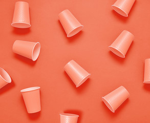 Plastic cups on living coral background.
