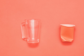 Plastic cups on living coral background.
