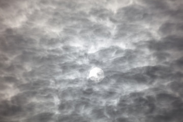 sun behind clouds