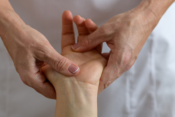 Professional massage therapist working on a woman hand and foot