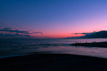 sunset over the  sea and fishermen