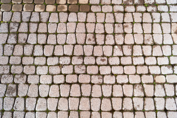 The road is made of stone tiles. Abstract texture for template.