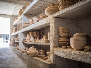 Preparing clay pottery for firing in adobe furnace, traditional moroccan berber craft, Fez, Morocco, North Africa