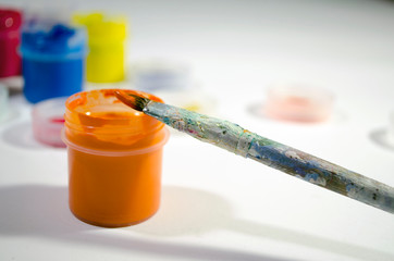 the artist paints a picture with color paints