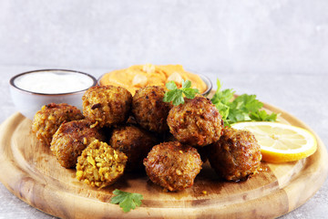 Traditional homemade hummus, falafel and chickpea served with spices on table. Jewish Cuisine.