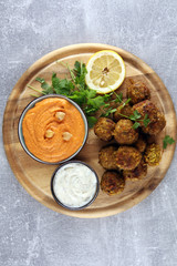 Traditional homemade hummus, falafel and chickpea served with spices on table. Jewish Cuisine.