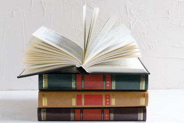Education and wisdom concept - open book on a stack of books