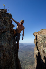 jung man hanging between 2 rocks on St Mary's Peak from the Flinders Ranges National Park