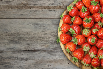 Strawberries on a plate on a wooden table