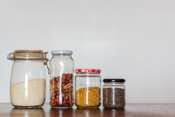 Food in glass jars on wooden table with copy space. Zero Waste, plastic free concept