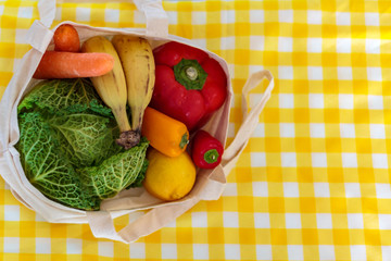 Top view of reusable shopping bag with fresh vegetables and fruits. Zero Waste, plastic free concept
