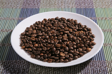 Fototapeta premium A scattering of coffee beans on a plate.