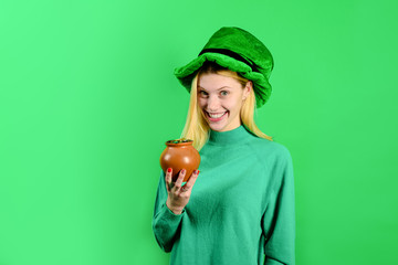 Green top hat. Blonde girl in in green top hat holds pot with gold. Leprechaun. Green leprechaun....