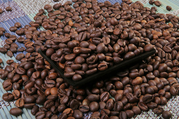 A scattering of coffee beans on a plate.