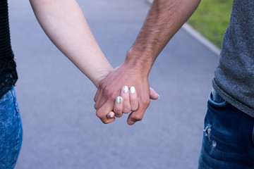 Close up of couple in love holding each other hands