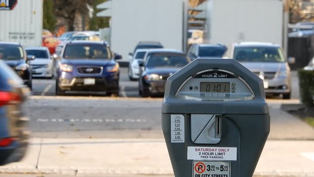 4K Zoomed Out Parking Meter As Cars Drive By