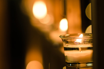 group of candles in perspective in the light of night, emotional background with candles