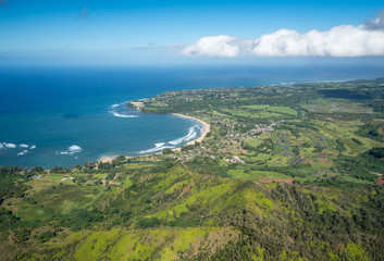 Fototapeta na wymiar Aerial view of Hanalei Bay and Princeville on hawaiian island of Kauai from helicopter flight