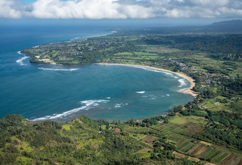 Fototapeta na wymiar Aerial view of Hanalei Bay and Princeville on hawaiian island of Kauai from helicopter flight