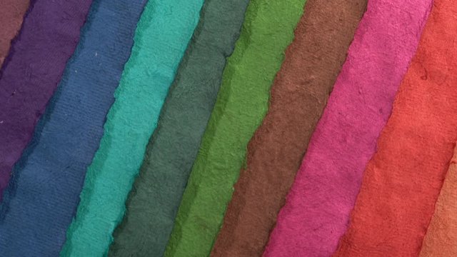 colorful sheets of handmade Huun paper created by Mayan artisans in Mexico from a tree bark - top view pan