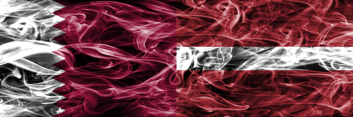 Obraz premium Qatar vs Latvia, Latvian smoke flags placed side by side. United Arab Emirates. UAE.