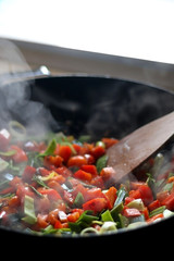 Carrots, red peppers and leek cooking in a wok. Selective focus. 
