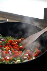 Carrots, red peppers and leek cooking in a wok. Selective focus. 