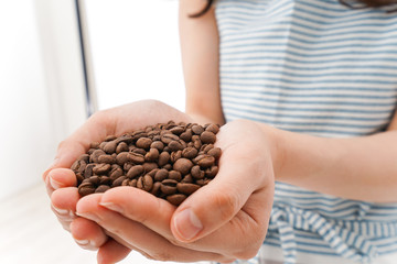 Obraz premium コーヒー豆を持つ若い女性