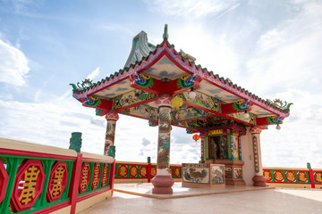 Fototapeta premium Ancient Chinese Shrine with Big Three face Guanyin statue and sky background,public landmark for tourist
