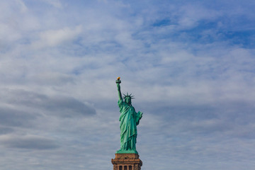Obraz premium Statue of Liberty against sky and clouds, in New York City, USA