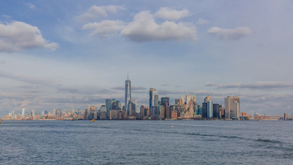 Buildings and skyscrapers of downtown Manhattan over water, in New York City, USA © Mark Zhu