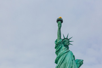 Fototapeta premium Statue of Liberty against sky and clouds, in New York City, USA