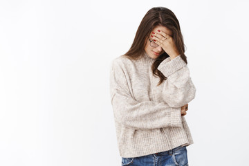 Oh gosh, embarrassing. Portrait of annoyed and fed up cute female in sweater and glasses making...