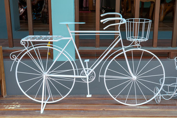 Fototapeta na wymiar Decorative metal white bicycle on the street in island Koh Phangan, Thailand