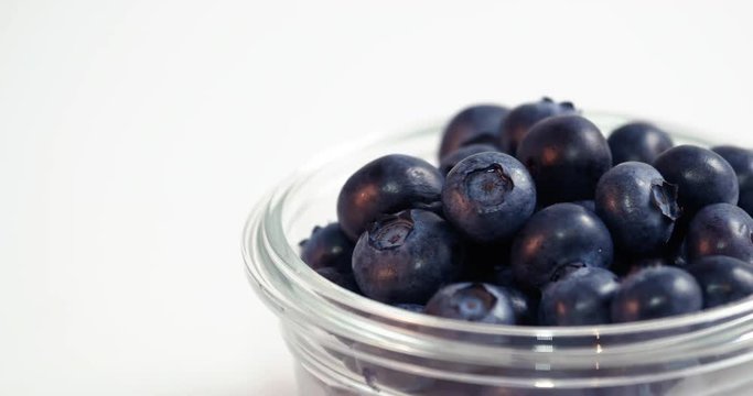 Blueberries in Glass Bowl Moving Across White Background Loop