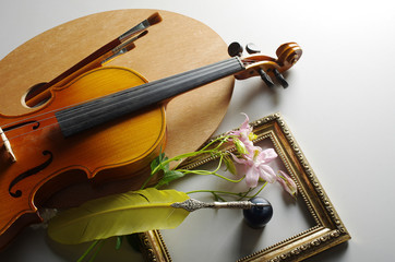 Fototapeta premium Art palette, brushes, violin, pen, notebook