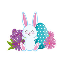 cute rabbit with easter egg painted in the garden