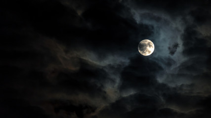 night sky with full moon in the clouds