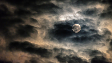 night sky with full moon in the clouds