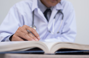 Doctor reading anatomy textbook