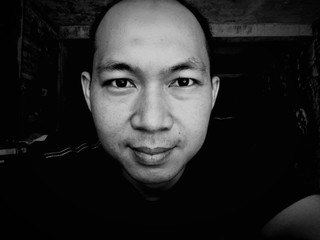 Asian man face smiling expression,close up shot in black and white